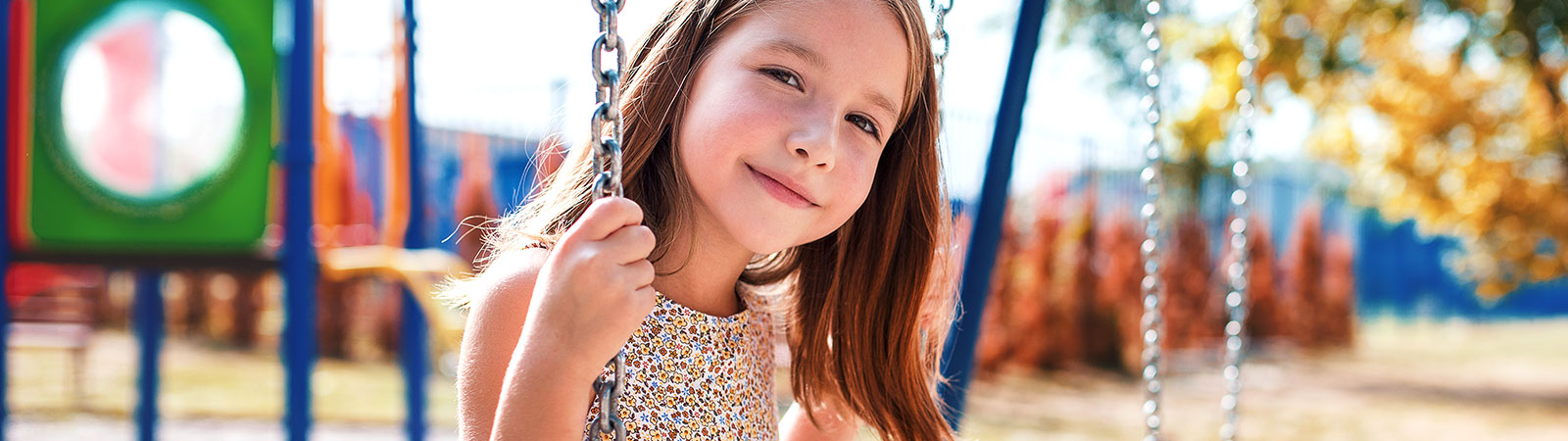 girl-on-a-playground-in-a-swing-1600x450